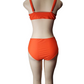 Orange bikini set on a mannequin against a white background