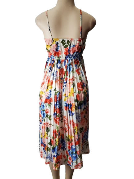 Colorful floral dress on a mannequin against a white background