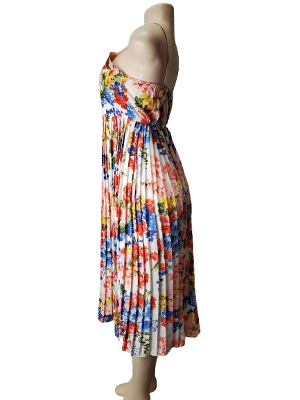 Mannequin wearing a colorful floral dress on a white background