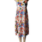Colorful floral dress on a mannequin against a white background