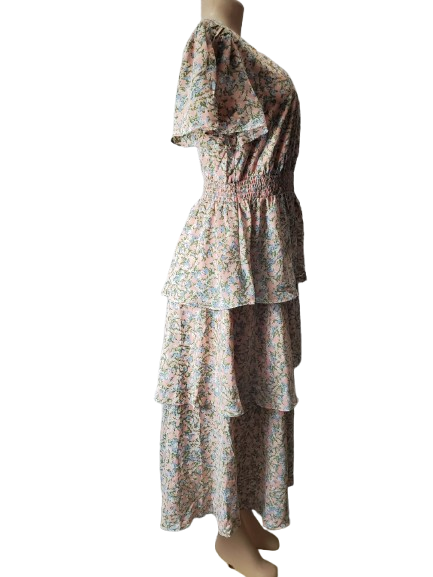 Floral dress on a mannequin against a white background