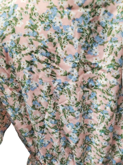 Close-up of a floral patterned fabric with pink, blue, and green colors.