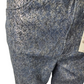Blue denim jeans with a tag on a white background