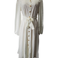 White dress with buttons on a mannequin against a white background