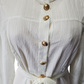 cream dress with gold buttons