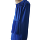 Blue dress with fringe details on a mannequin against a white background