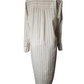 Mannequin wearing a long, light-colored dress with vertical stripes on a white background