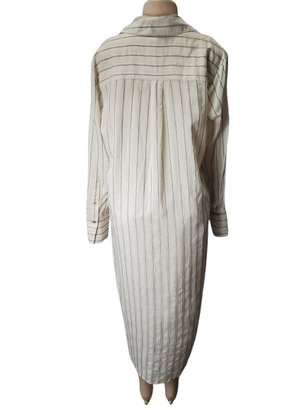 Mannequin wearing a long, light-colored dress with vertical stripes on a white background