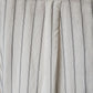 Close-up of a fabric with thin black stripes on a light gray background