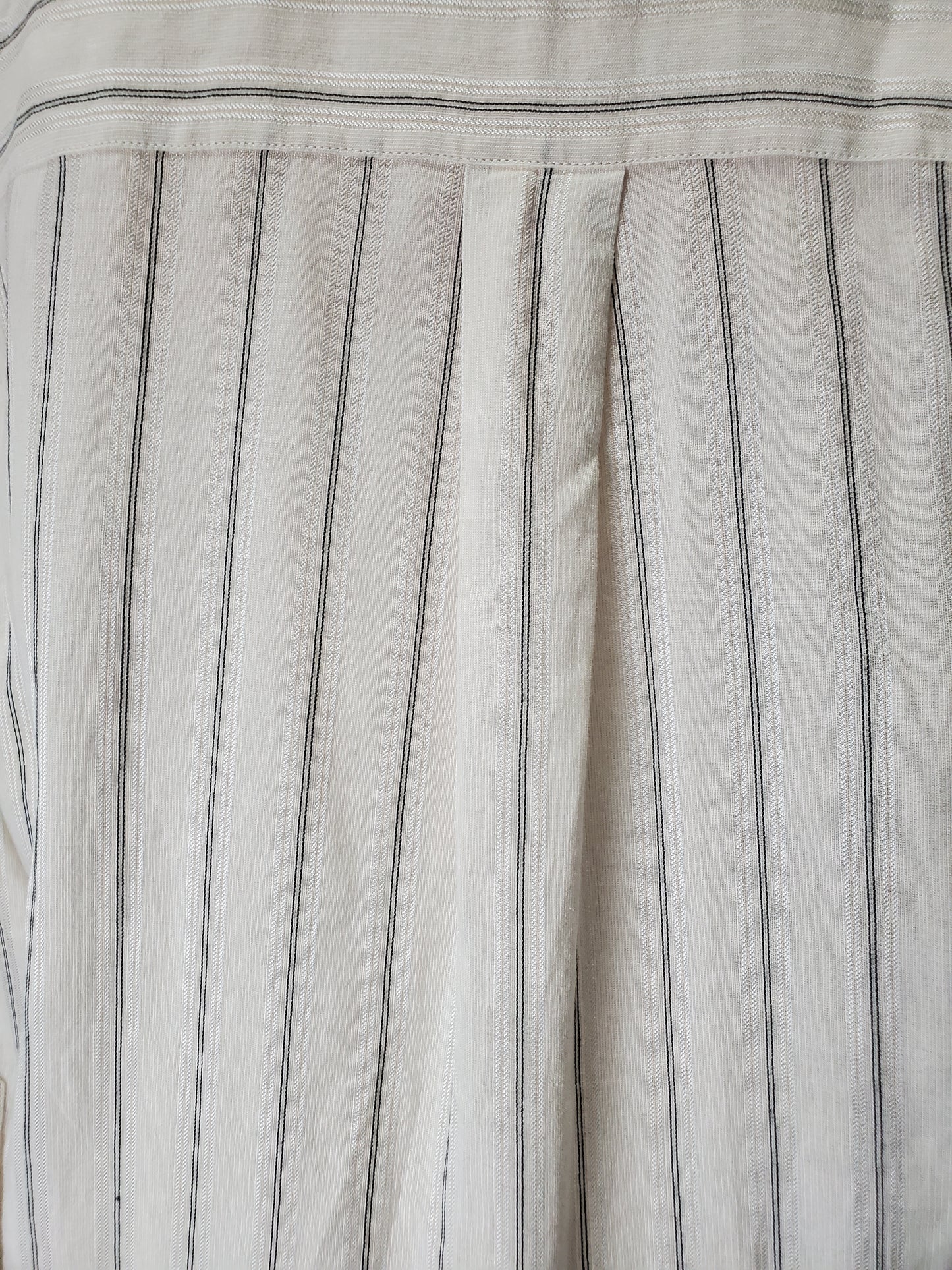 Close-up of a fabric with thin black stripes on a light gray background