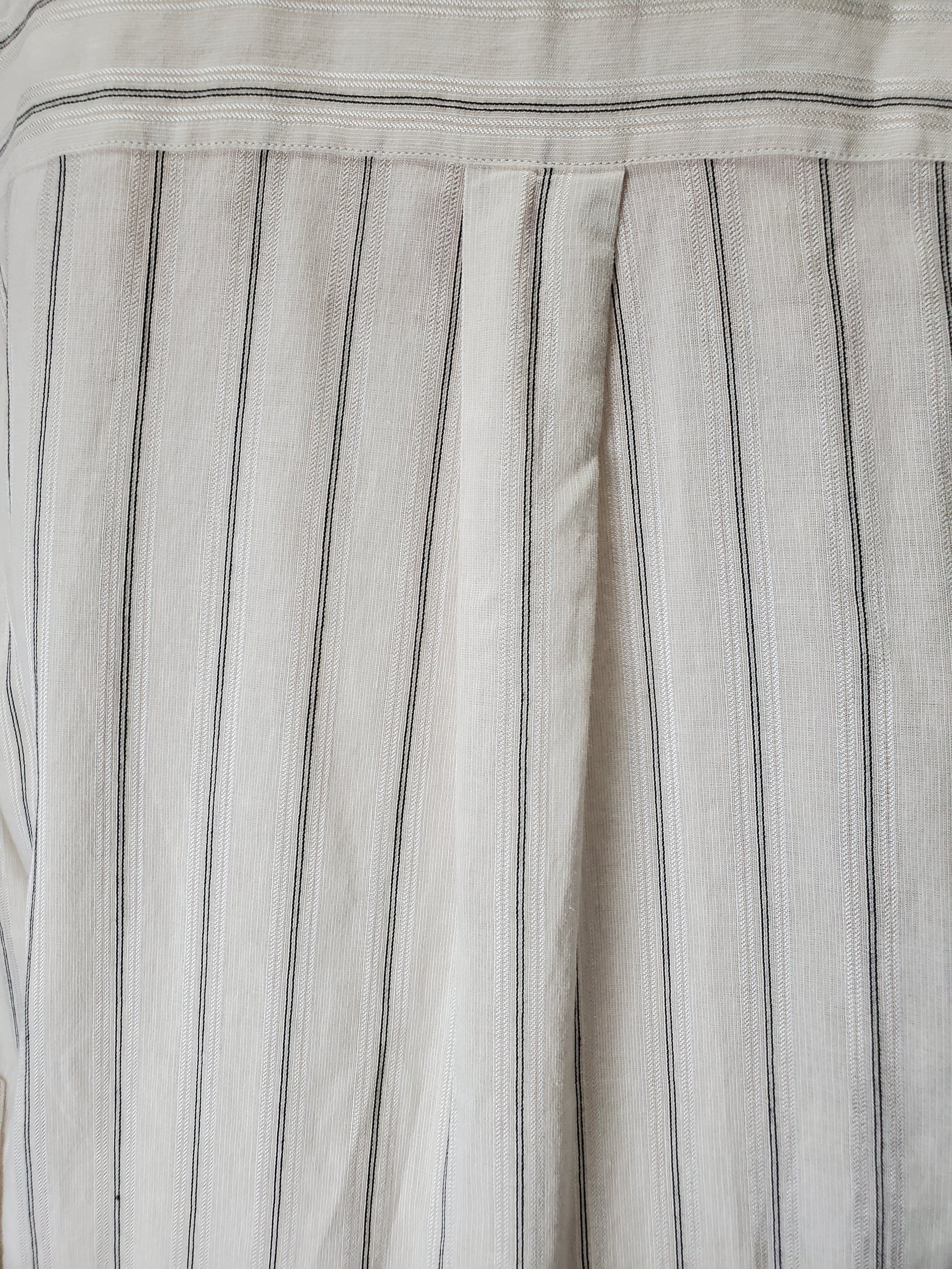 Close-up of a fabric with thin black stripes on a light gray background