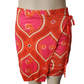 Orange and pink patterned skirts on a mannequin against a white background