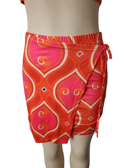Orange and pink patterned skirts on a mannequin against a white background