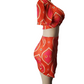 orange patterned two-piece outfit on a mannequin against a white background
