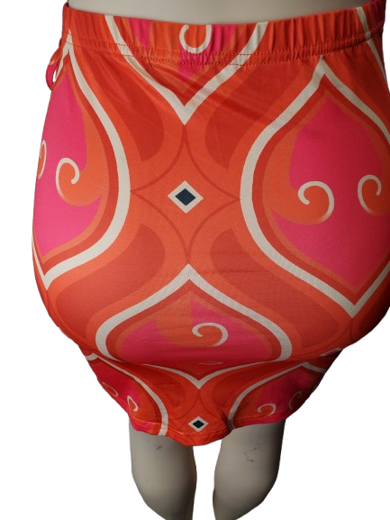 Colorful patterned skirt on a mannequin against a white background