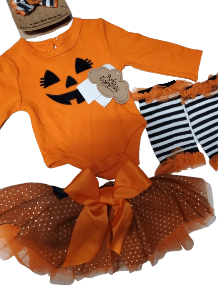 Halloween-themed baby outfit with orange long-sleeve shirt, tutu, and striped socks on a white background.