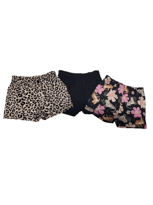 Two pairs of patterned shorts  on a white background