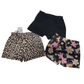 Two pairs of shorts with leopard print and floral design on a white background