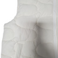Close-up of a white quilted mattress with circular patterns on a white background