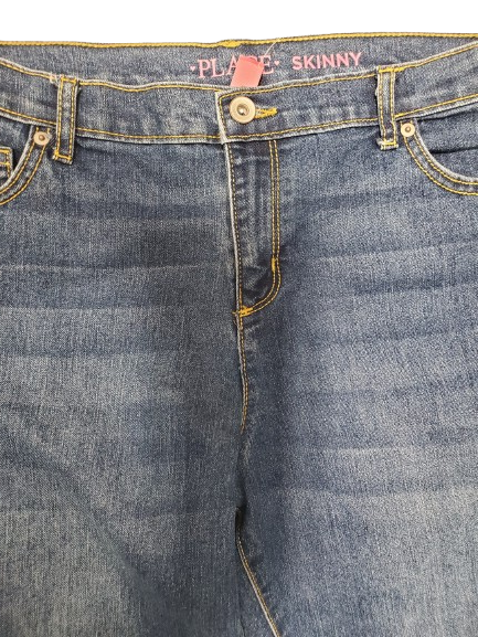 Close-up of blue denim jeans with brand label