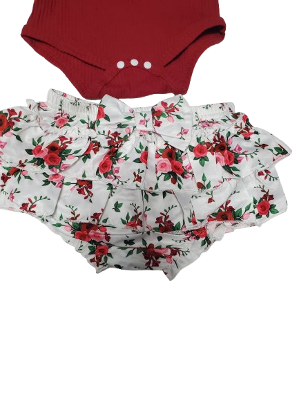 Red onesies and floral shorts on a white background