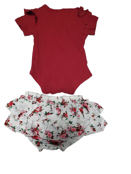 Red sleeveless top and floral-patterned fabric on a white background