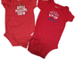 Two red baby onesies with text on a white background