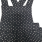 Black polka dot pinafore dress with a heart design on a white background