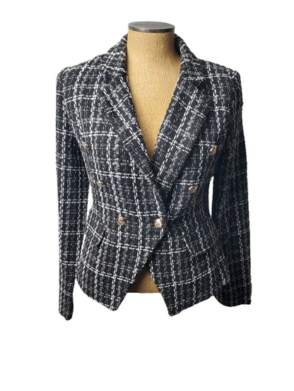 Plaid blazer on a mannequin against a white background