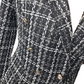 Close-up of a black and white checkered blazer with gold buttons on a white background