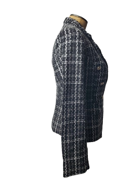 Black and white checkered suit jacket on a mannequin against a white background