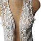 beige lace shrug on a mannequin against a white background