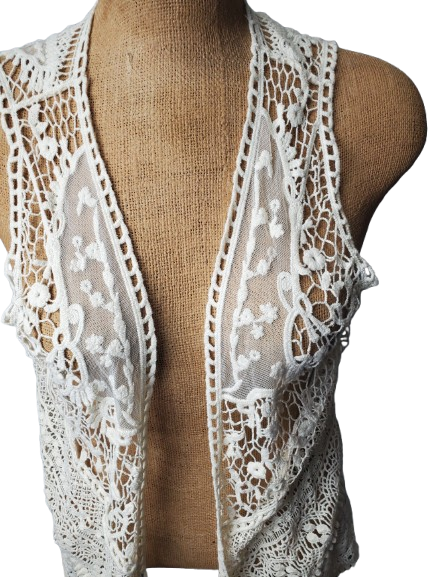 beige lace shrug on a mannequin against a white background