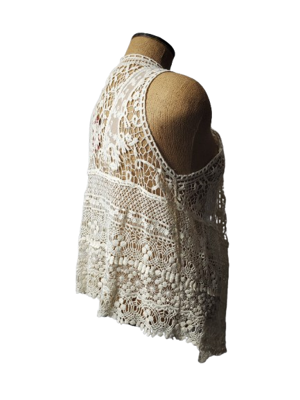 beige crochet top on a mannequin against a white background