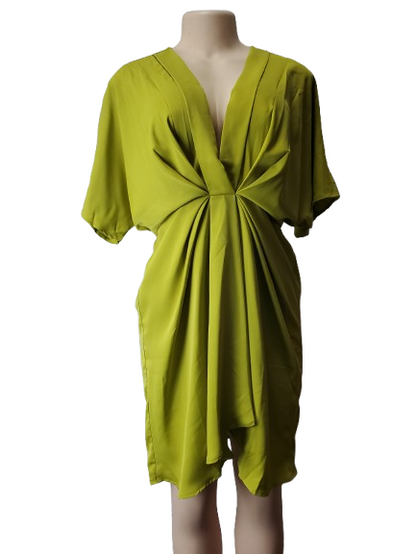 Green dress on a mannequin against a white background