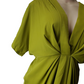 Green dress on a mannequin against a white background