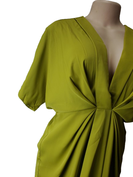 Green dress on a mannequin against a white background