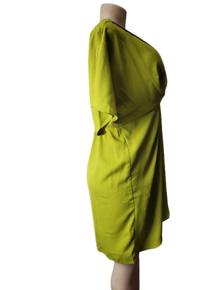 Green dress on a mannequin against a white background