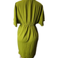 Green dress on a mannequin against a white background