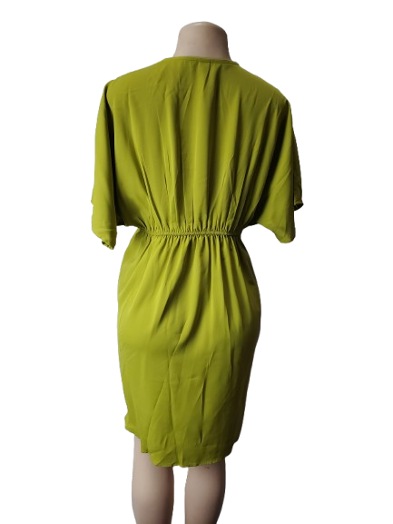 Green dress on a mannequin against a white background