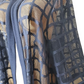 Sheer mesh fabric with geometric pattern on a mannequin against a white background