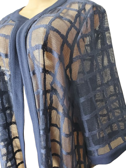 Sheer mesh fabric with geometric pattern on a mannequin against a white background