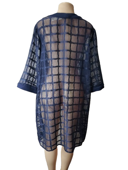 Sheer blue grid patterned dress on a mannequin against a white background