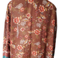 Floral patterned blouse on a mannequin against a white background