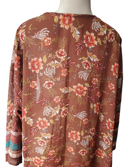 Floral patterned blouse on a mannequin against a white background