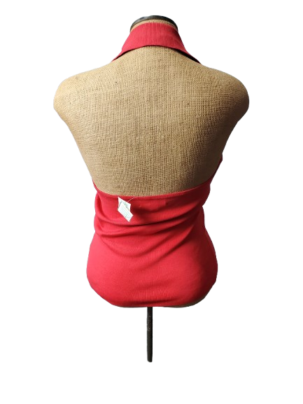 Mannequin wearing a red top and beige vest on a white background