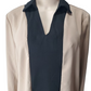 Mannequin wearing a beige cardigan over a navy shirt on a white background