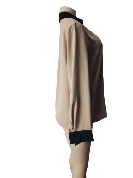 Beige dress with black accents on a white background