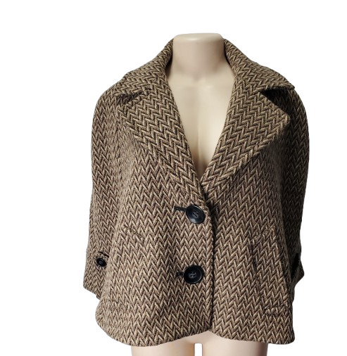 Herringbone patterned coat on a mannequin against a white background