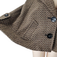 Brown herringbone patterned coat on a mannequin with a white background